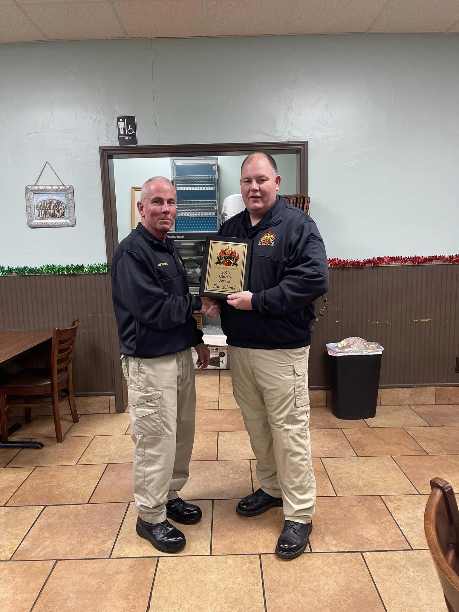 Photo of two men holding an award