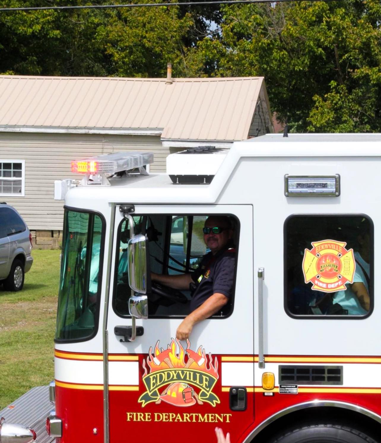 Photo of a fireman driving a fire truck