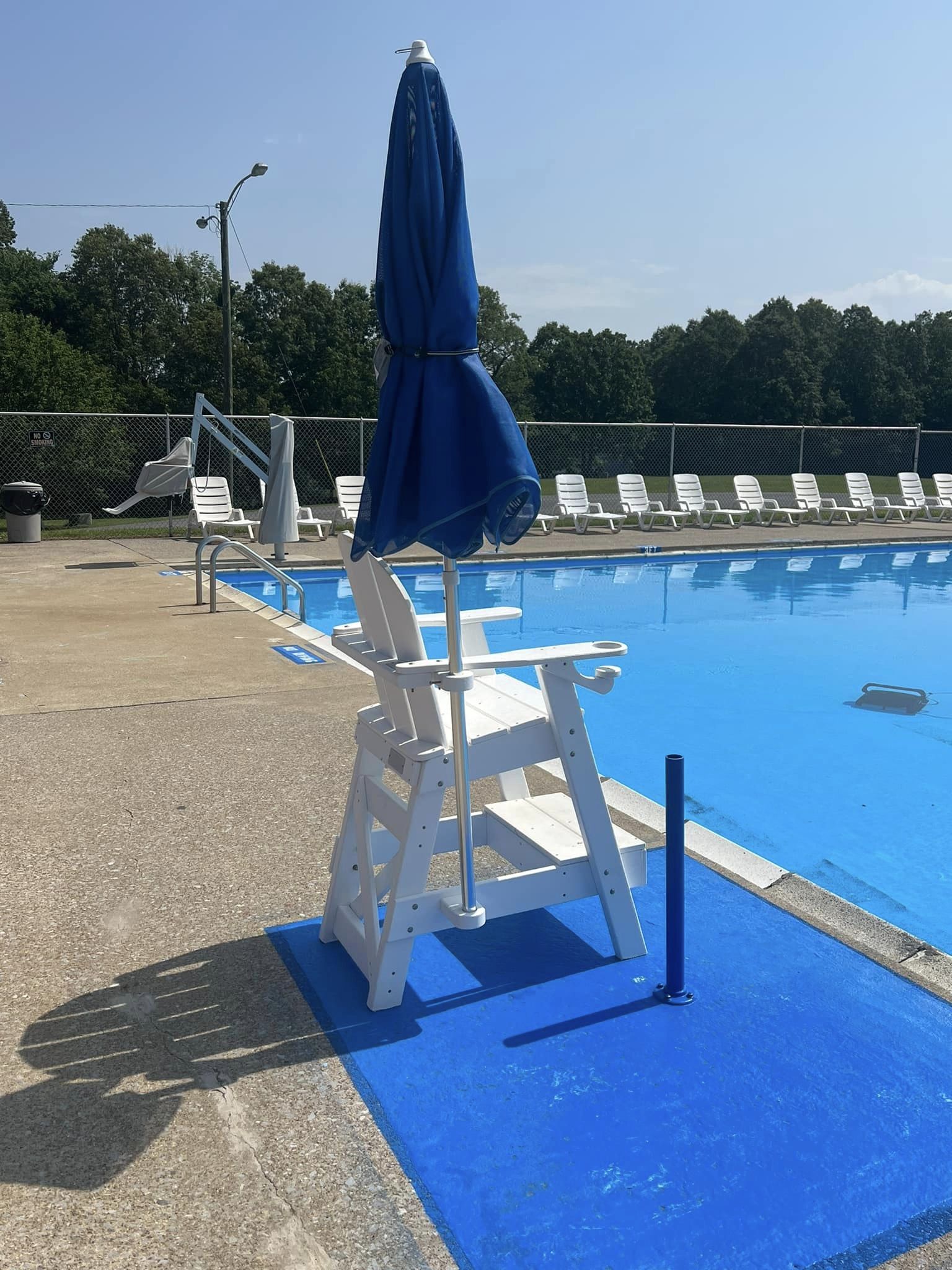 Photo of a lifeguard chair overlooking the pool