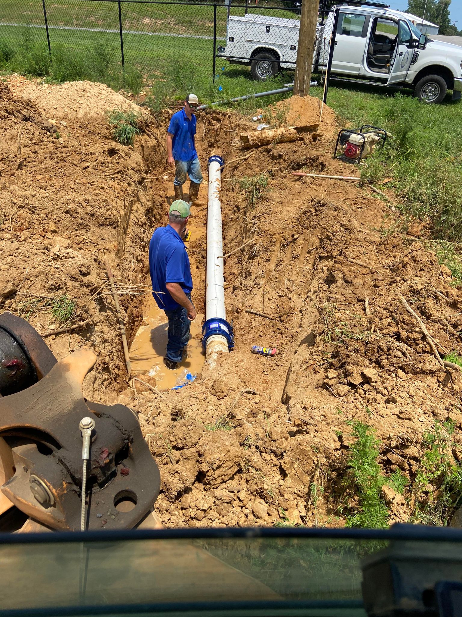 Photo of workers installing a water pipe