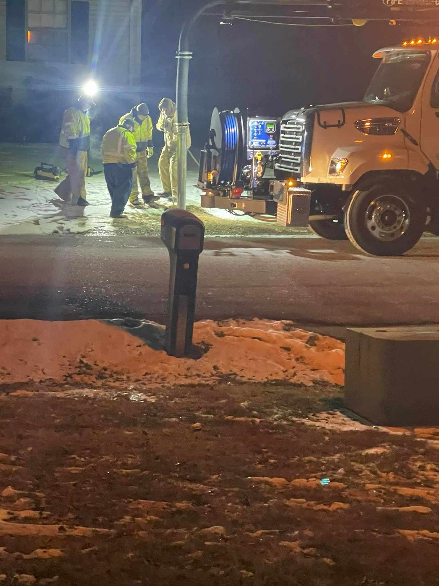 Photo of workers outside at night